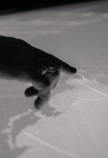 Hands point on a cyber space table Magnolia Srl - We do networking